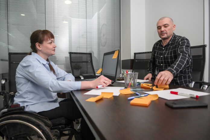 businesswoman-wheelchair-orange-post-it-notes